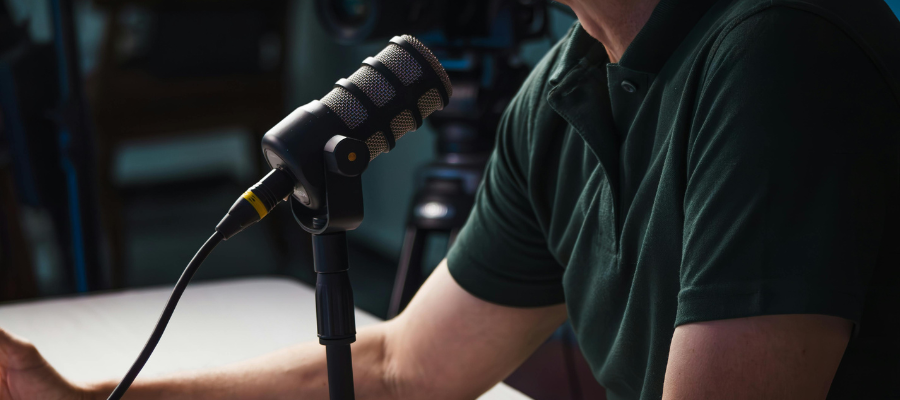 A person in a green top talking into a microphone