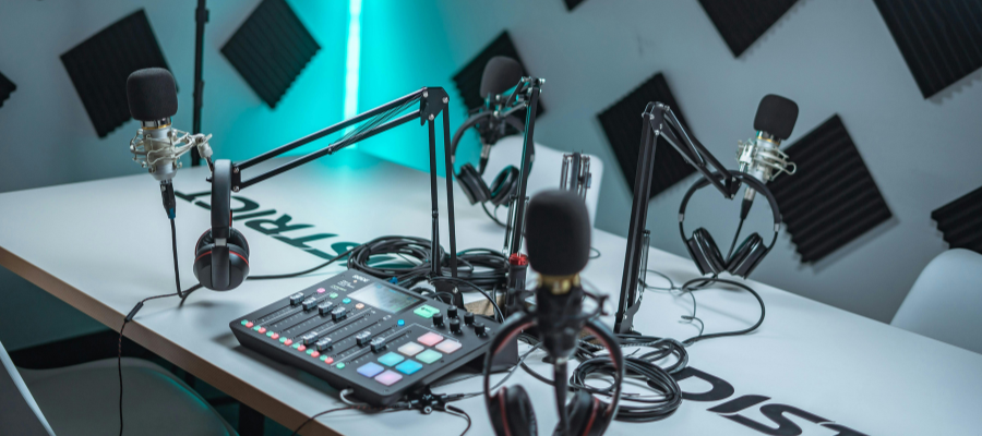 A mix-amp with 3 microphones and 3 headphones in a podcast studio in lancashire