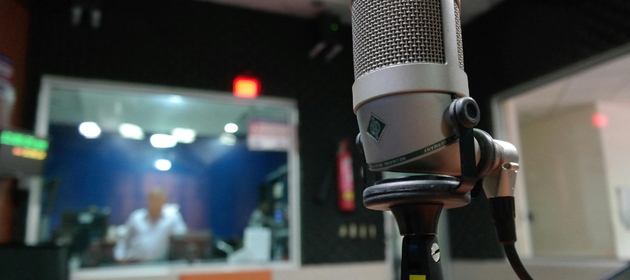 A recording booth and a microphone close to the camera.