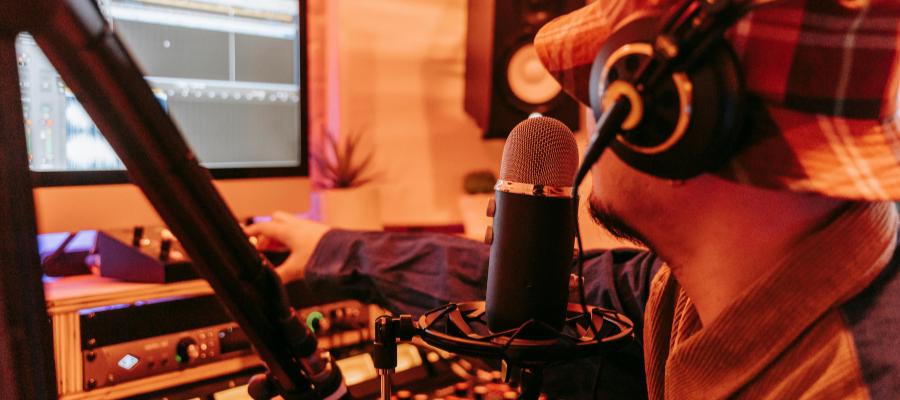 Someone in a bucket had with headphones on and a microphone in front of them directing a podcast in Burnley.