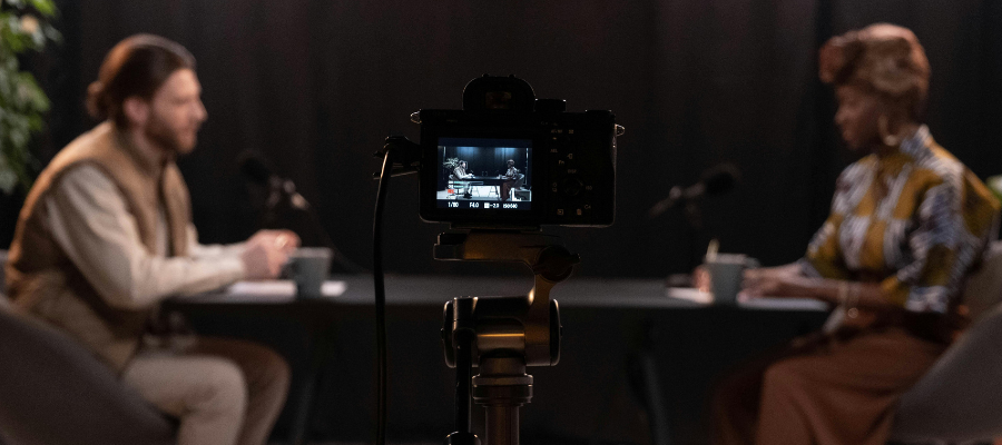 2 people sat at a table filming a podcast in padiham.